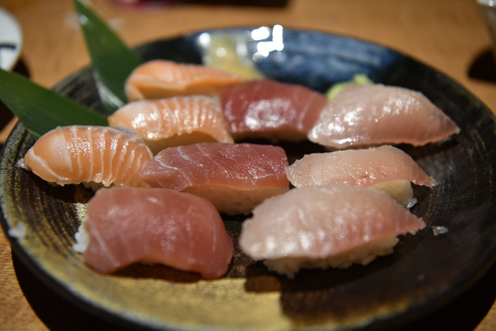 Assorted nigiri sushi on a decorative plate