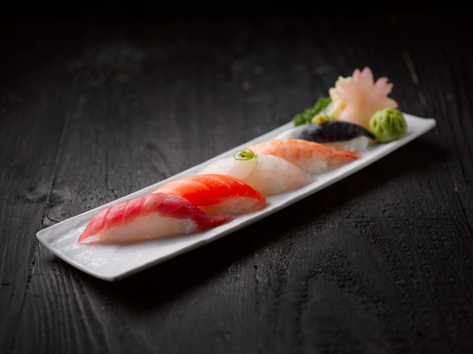 Elegant assortment of sushi on a dark wood table