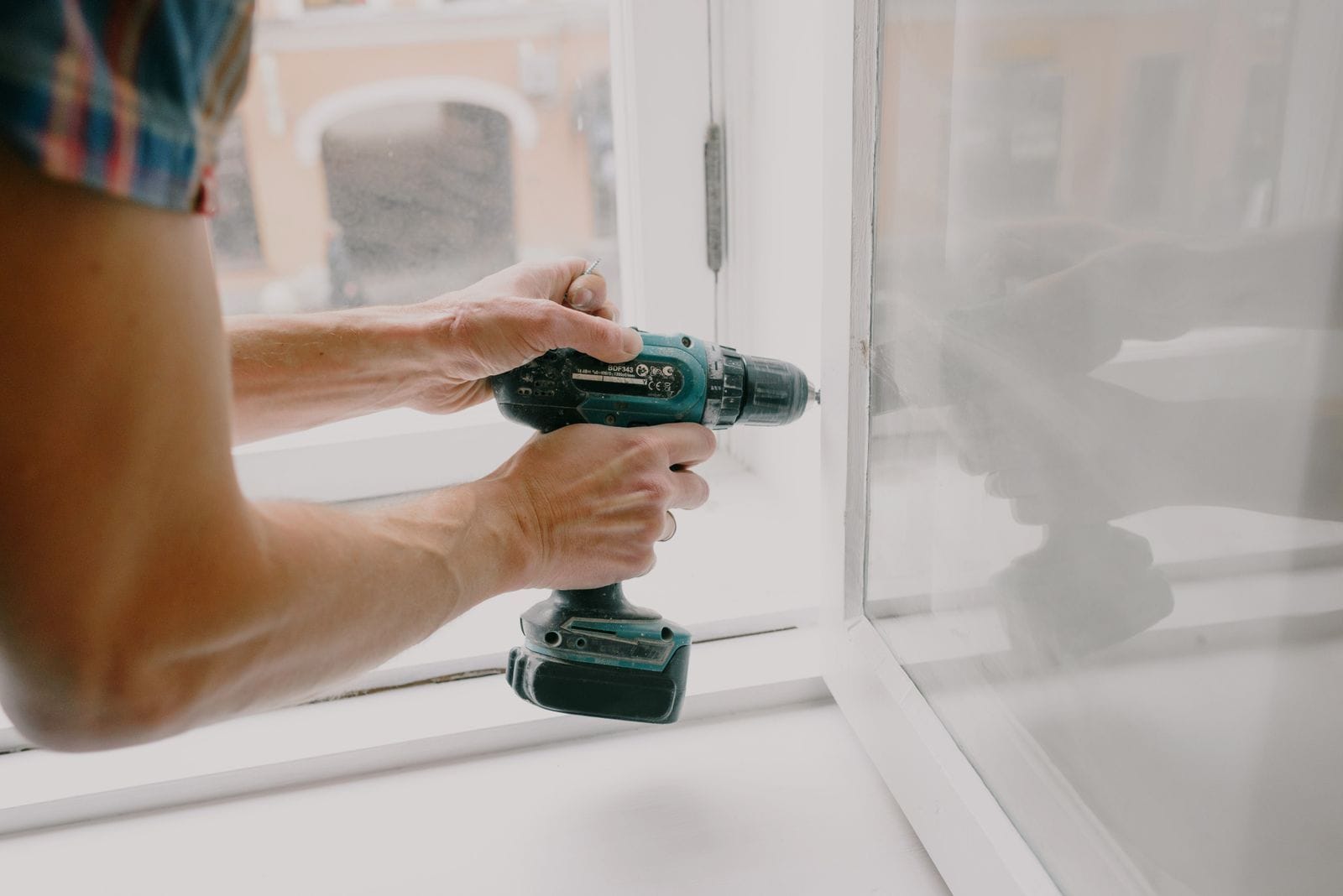 Handyman using a power drill during a residential repair